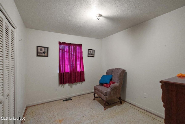 2530 Crestleigh Mnr, Jackson, MS 39204 - living area with baseboards, tile patterned floors, and a textured ceiling