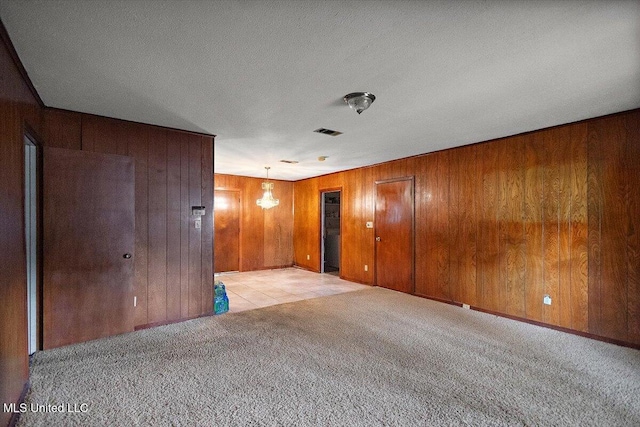 2530 Crestleigh Mnr, Jackson, MS 39204 - empty room with light carpet, wood walls, and a textured ceiling