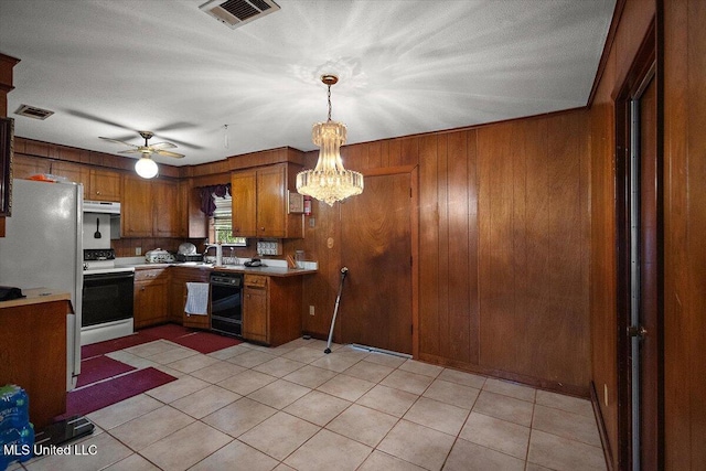 2530 Crestleigh Mnr, Jackson, MS 39204 - kitchen with dishwasher, electric range oven, brown cabinetry, under cabinet range hood, and wooden walls