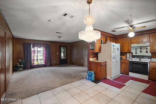 2530 Crestleigh Mnr, Jackson, MS 39204 - kitchen featuring white appliances, under cabinet range hood, brown cabinets, light carpet, and light countertops