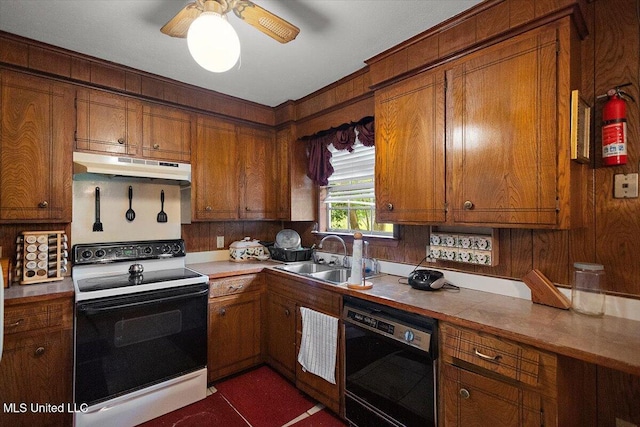 2530 Crestleigh Mnr, Jackson, MS 39204 - kitchen featuring range with electric stovetop, under cabinet range hood, dishwashing machine, a sink, and brown cabinets