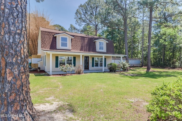 5416 Riley Rd, Ocean Springs, MS 39564 - view of front facade featuring covered porch, a shingled roof, and a front yard