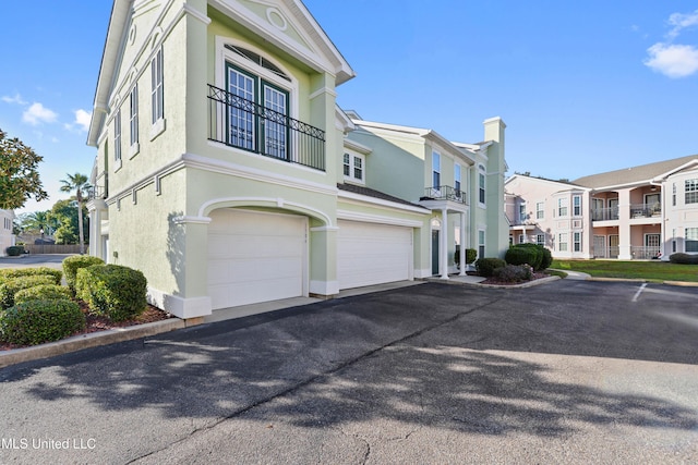 exterior space with a balcony and a garage