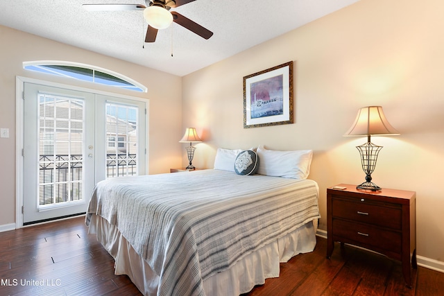 bedroom featuring access to exterior, ceiling fan, dark wood-type flooring, and a textured ceiling