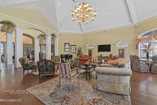 living room with ornate columns, dark wood-type flooring, high vaulted ceiling, beamed ceiling, and a chandelier