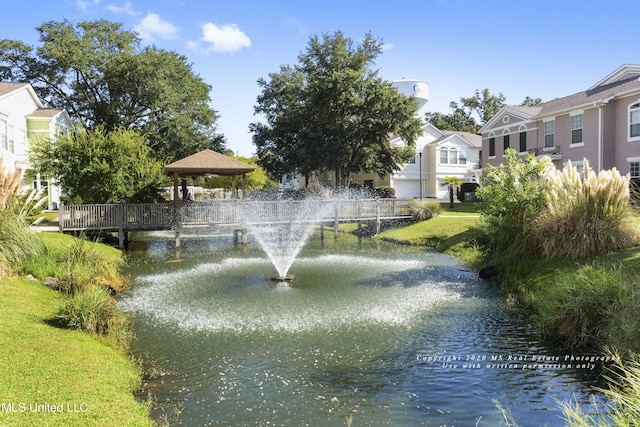 view of community featuring a gazebo and a water view