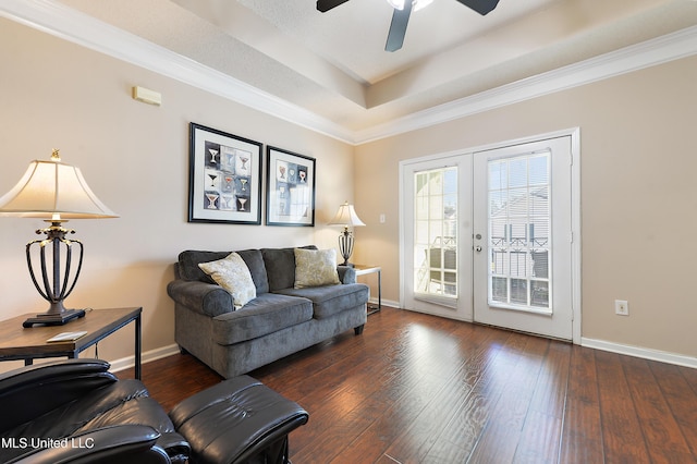 living room with dark hardwood / wood-style floors, ceiling fan, and ornamental molding