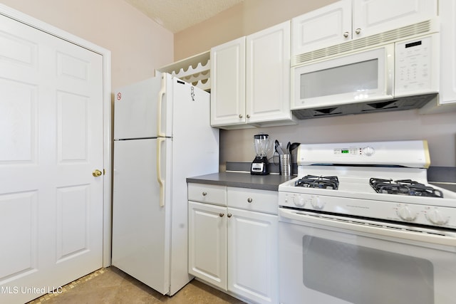 kitchen with white cabinets, white appliances, and a textured ceiling