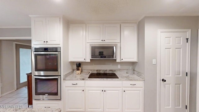 136 Westlake Dr, Brandon, MS 39047 - kitchen with stainless steel appliances, white cabinets, light stone countertops, and light tile patterned flooring