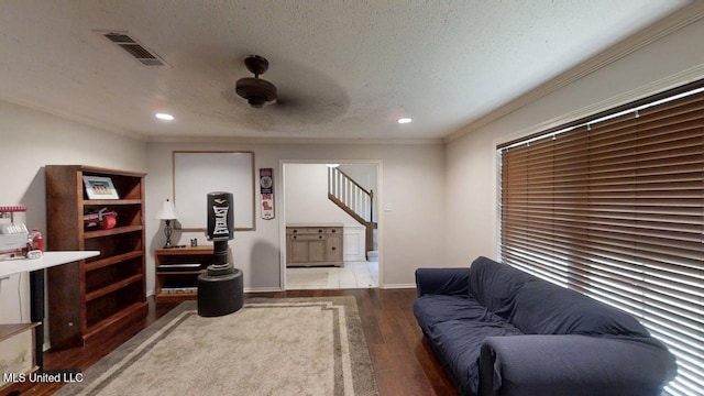 136 Westlake Dr, Brandon, MS 39047 - living room with wood finished floors, a textured ceiling, ornamental molding, recessed lighting, and stairs