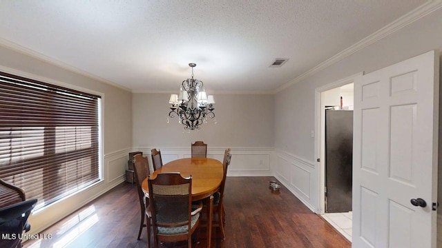 136 Westlake Dr, Brandon, MS 39047 - dining room with a chandelier, wood finished floors, ornamental molding, and a wainscoted wall
