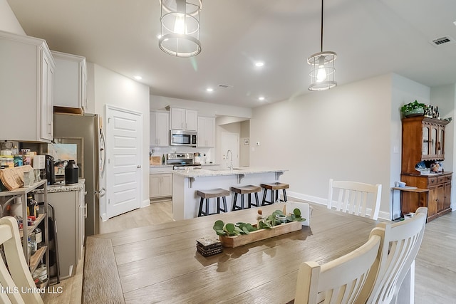 dining space featuring light wood-type flooring