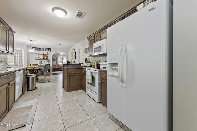 22807 Alamosa Dr, Moss Point, MS 39562 - kitchen with light tile patterned floors, white appliances, a peninsula, visible vents, and open floor plan