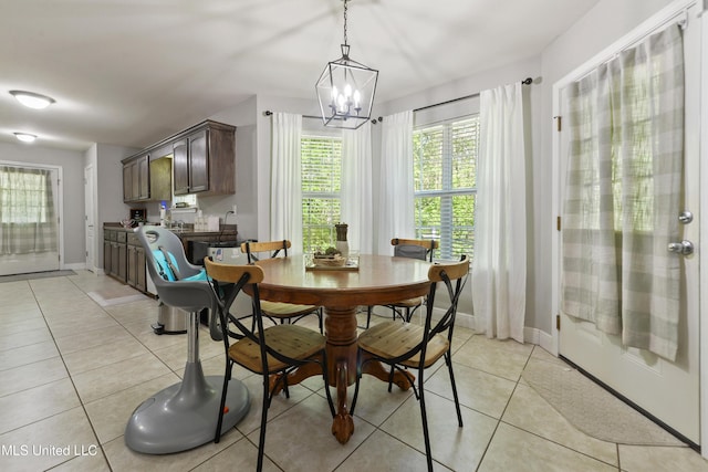 22807 Alamosa Dr, Moss Point, MS 39562 - dining area featuring a chandelier, light tile patterned floors, and baseboards