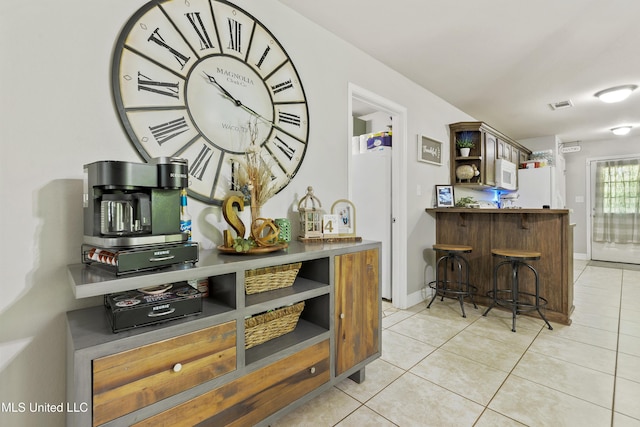 22807 Alamosa Dr, Moss Point, MS 39562 - bar featuring visible vents, baseboards, white appliances, and light tile patterned floors