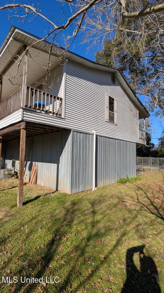 view of side of property with a yard