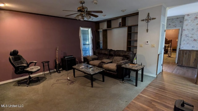 unfurnished living room featuring ornamental molding, ceiling fan, and wood-type flooring