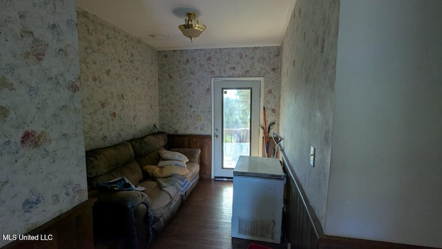 living room featuring dark hardwood / wood-style flooring and crown molding