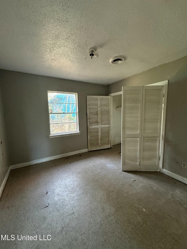 unfurnished bedroom with a textured ceiling