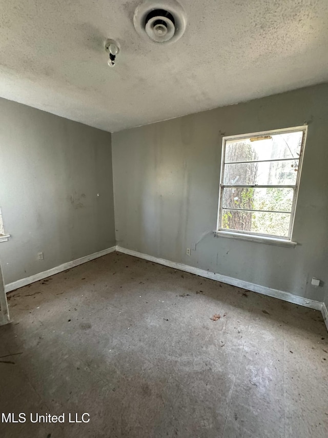 empty room featuring a textured ceiling