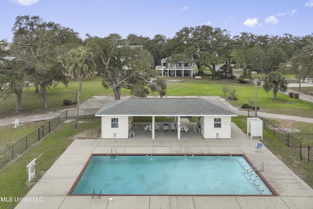 view of swimming pool with a yard and a patio