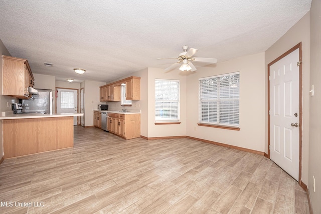 kitchen with kitchen peninsula, sink, dishwasher, and light hardwood / wood-style flooring