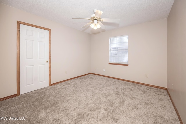 carpeted spare room featuring ceiling fan and a textured ceiling