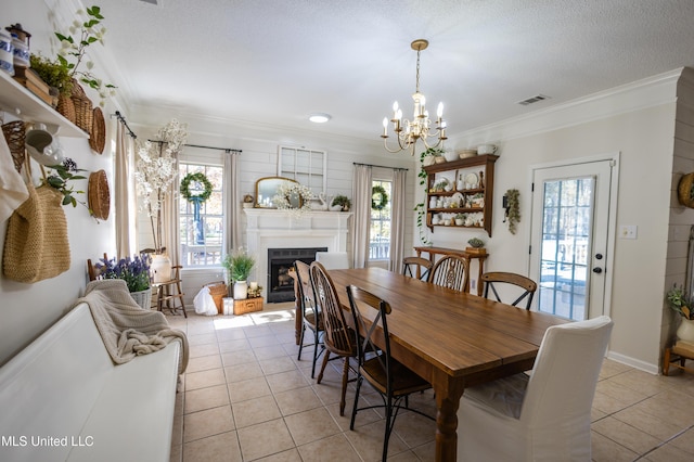 dining area featuring a wealth of natural light, light tile patterned floors, and ornamental molding