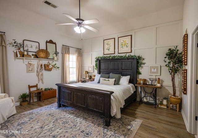 bedroom with hardwood / wood-style floors and ceiling fan