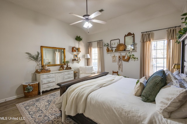 bedroom with hardwood / wood-style floors, ceiling fan, and vaulted ceiling