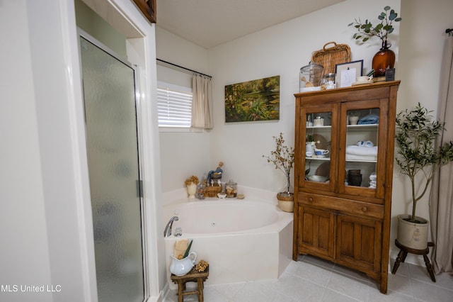 bathroom with tile patterned floors and independent shower and bath