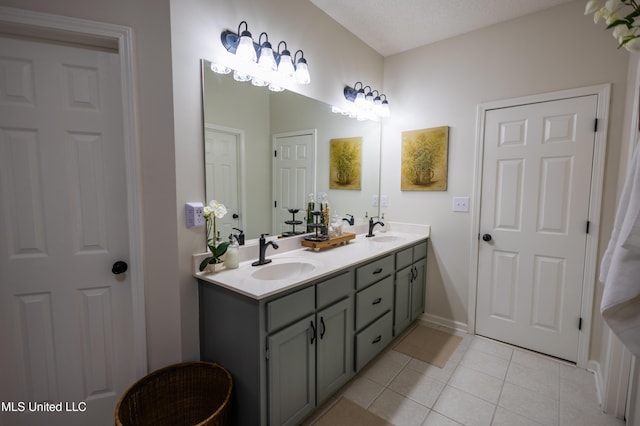 bathroom featuring tile patterned flooring, a textured ceiling, and vanity