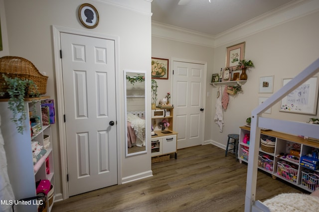 game room featuring hardwood / wood-style flooring and crown molding