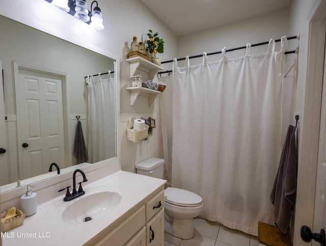 bathroom featuring tile patterned flooring, vanity, and toilet