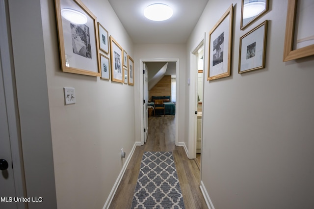 hallway with hardwood / wood-style flooring