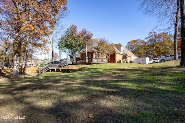 view of yard featuring a wooden deck