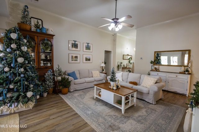 living room with ceiling fan, hardwood / wood-style floors, and ornamental molding