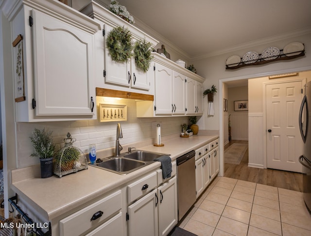 kitchen featuring light hardwood / wood-style flooring, white cabinets, stainless steel appliances, and sink