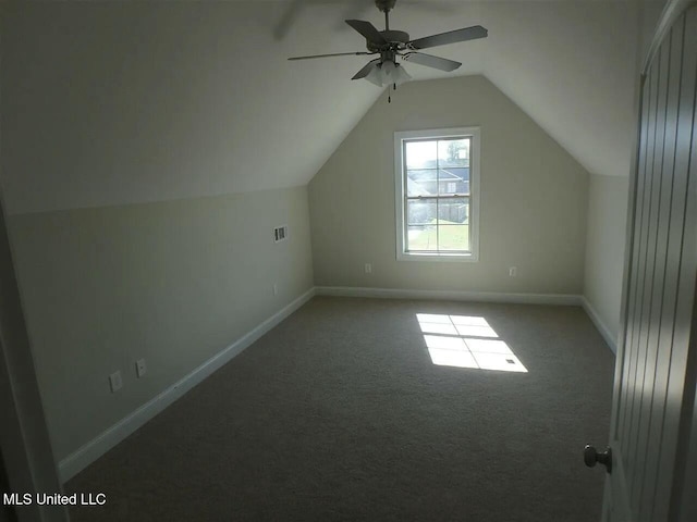 additional living space featuring a ceiling fan, baseboards, visible vents, vaulted ceiling, and carpet flooring