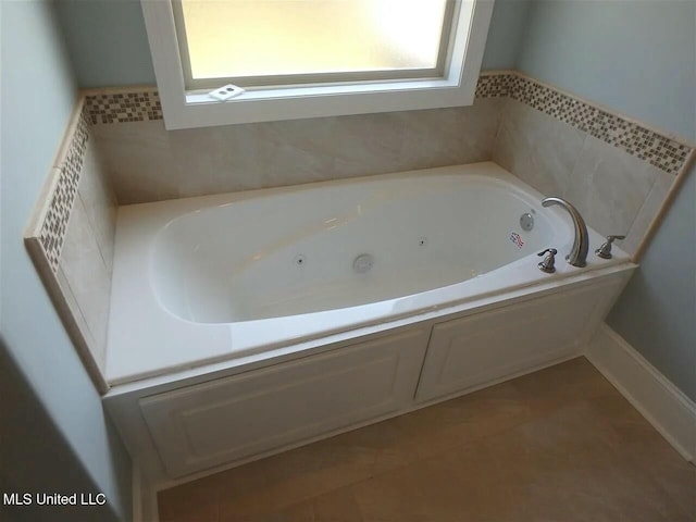 bathroom featuring tile patterned floors and a whirlpool tub