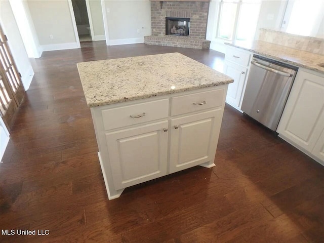 kitchen with a kitchen island, dishwasher, white cabinetry, and dark wood-type flooring