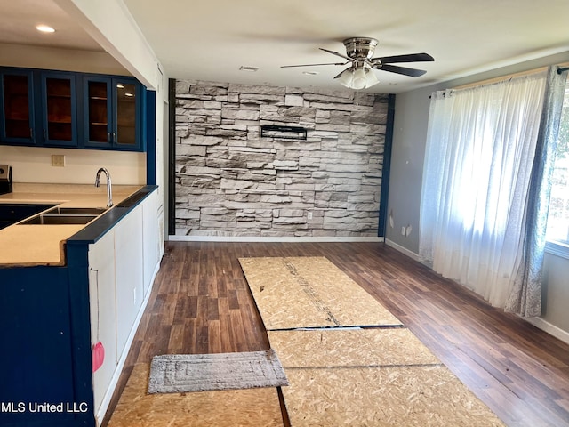 interior space featuring dark hardwood / wood-style flooring, sink, and ceiling fan