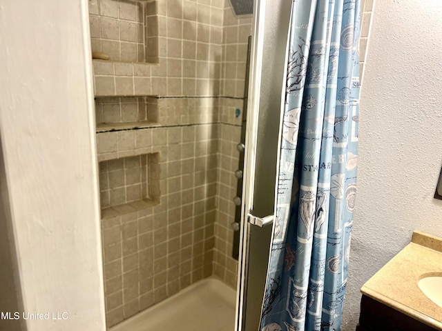 bathroom featuring vanity and a shower with curtain