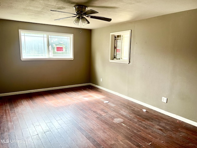 empty room featuring hardwood / wood-style floors, a textured ceiling, and ceiling fan