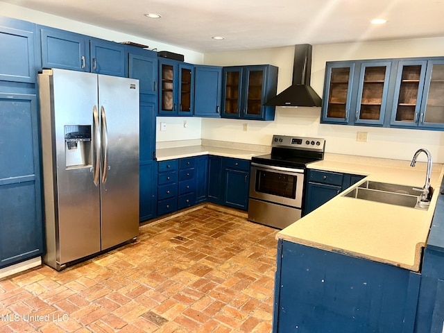 kitchen featuring blue cabinets, appliances with stainless steel finishes, sink, and wall chimney exhaust hood