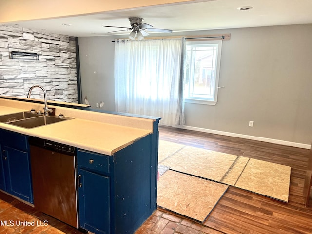 kitchen with dark wood-type flooring, stainless steel dishwasher, blue cabinets, and sink