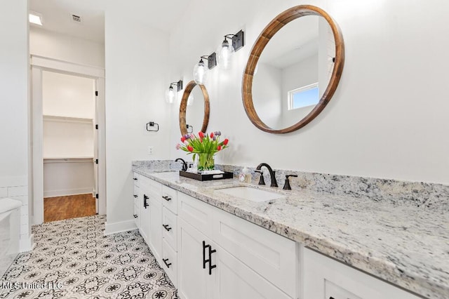 bathroom with vanity and tile patterned flooring