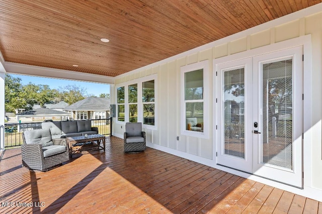 wooden deck featuring outdoor lounge area and french doors