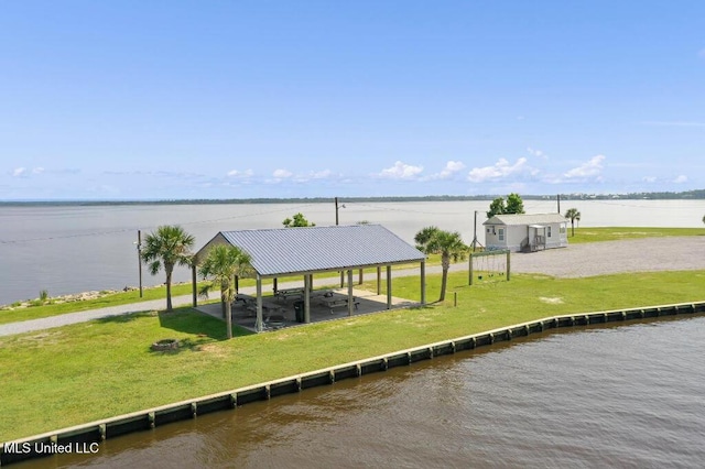 view of dock with a water view and a yard