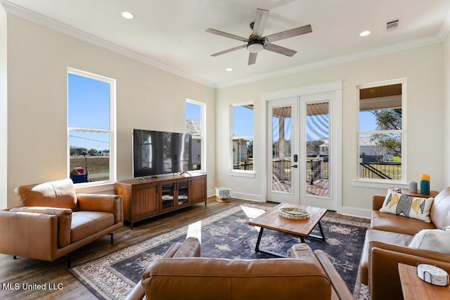 living room with ornamental molding, dark wood-type flooring, ceiling fan, and french doors